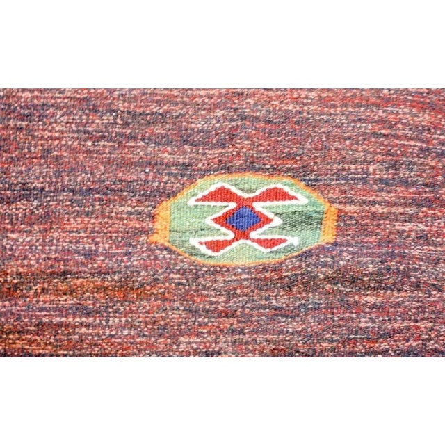 An incredible vintage Persian Gabbeh Kilim rug woven in crimson and indigo wool with an asymmetrical design containing two...