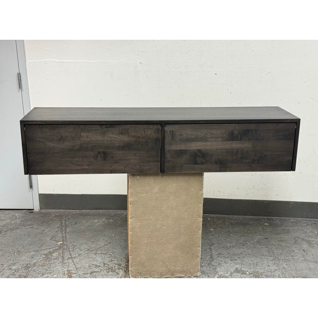 Design Plus Gallery presents the Hover Wall-Mounted Cabinet by Room and Board. This cabinet has a maple wood grain surface...