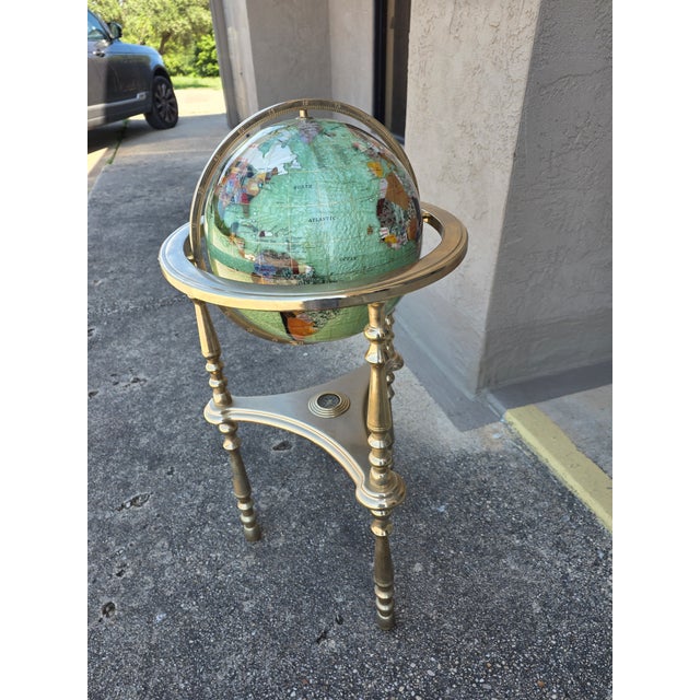 Beautiful floor stand in brass with a compas and stunning gemstone set globe.