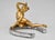 This exceptional Art Nouveau bronze sculpture by Georges Récipon depicts a nude female figure reclining on a horseshoe....
