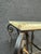 Black iron base Victorian pedestal/plant stand with light marble top, featuring hues of green, white, brown and orange....