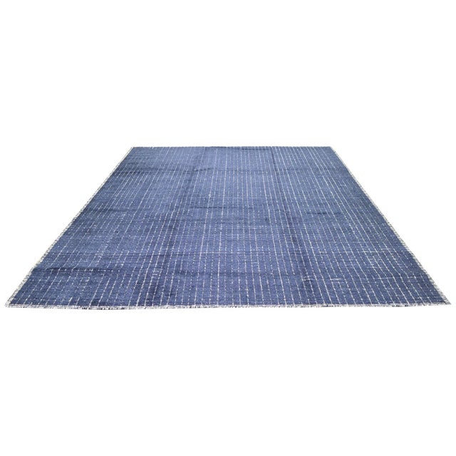 Hand-knotted with care using traditional rug-making techniques, this wool rug blends timeless craftsmanship with a modern...