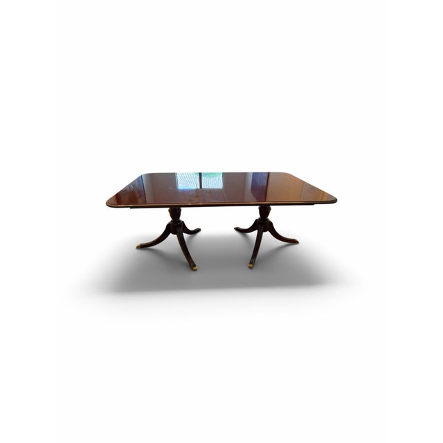Solid mahogany table and chairs. Set includes six chairs (2 armchairs, 4 side chairs). Also includes two 18 inch table...