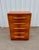 Elegant American Streamline Moderne chest featuring dramatic bookmatched walnut veneers, rounded waterfall edges, and...