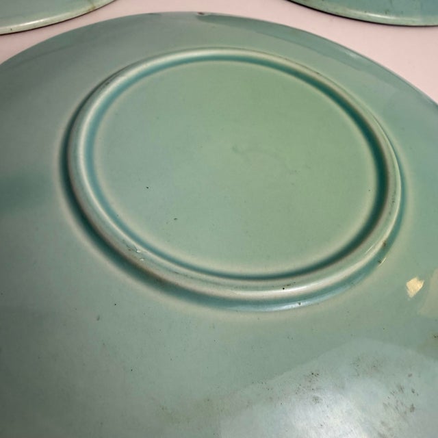 A charming set of four majolica plates featuring two swallow birds in flight on each plate. The glaze palette is a soft,...