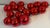 Set of 16 red glass holiday ball ornaments.