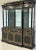 An impressive black lacquered and gilt decorated breakfront display cabinet by Karges Furniture, executed in an elegant...