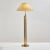 Floor lamp with triple brass stem. With stains on the textile lampshade and surface scratches on the metal parts. The...