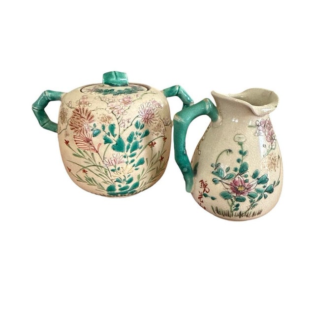 A beautifully coordinated vintage Japanese tea service featuring hand-painted floral decoration over a warm crackle glaze...