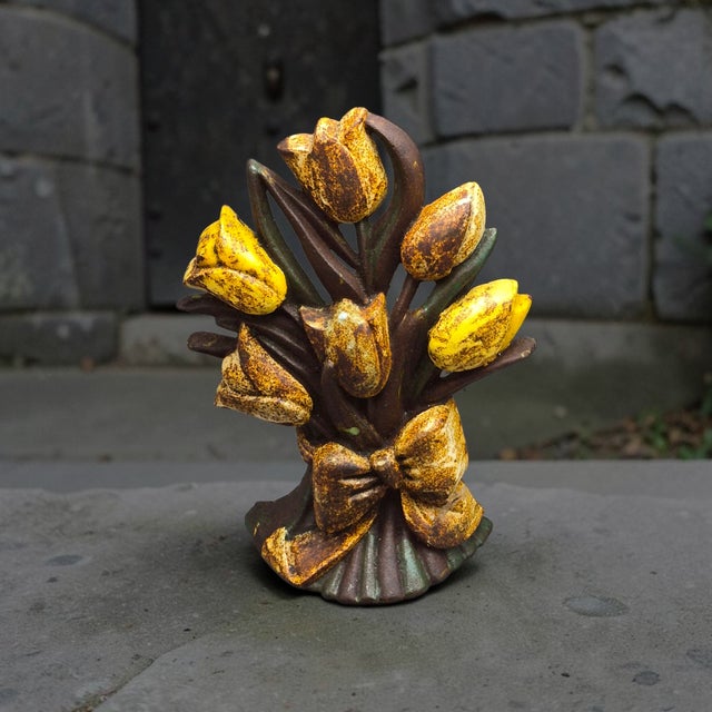 The Antique Cast Iron Yellow Tulip Flower Bouquet Doorstop is a vintage door stop made of cast iron, featuring a beautiful...