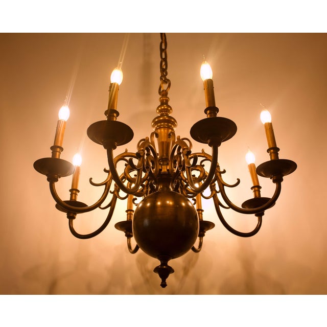 A monumental antique dutch-style bronze chandelier featuring eight arms, dating back to the first half of the 19th...