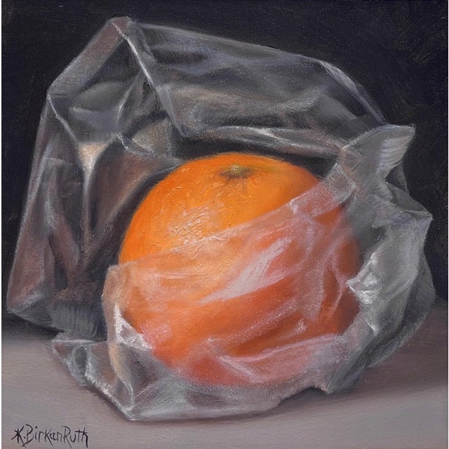 Orange Wrapped in Plastic by Kelly Birkenruth | Oil on Panel Still life of an orange in plastic wrap For Sale