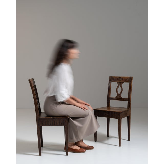 This pair of 19th century carved oak chairs from France, made in dark oak with pierced, shaped backs and solid seats. The...