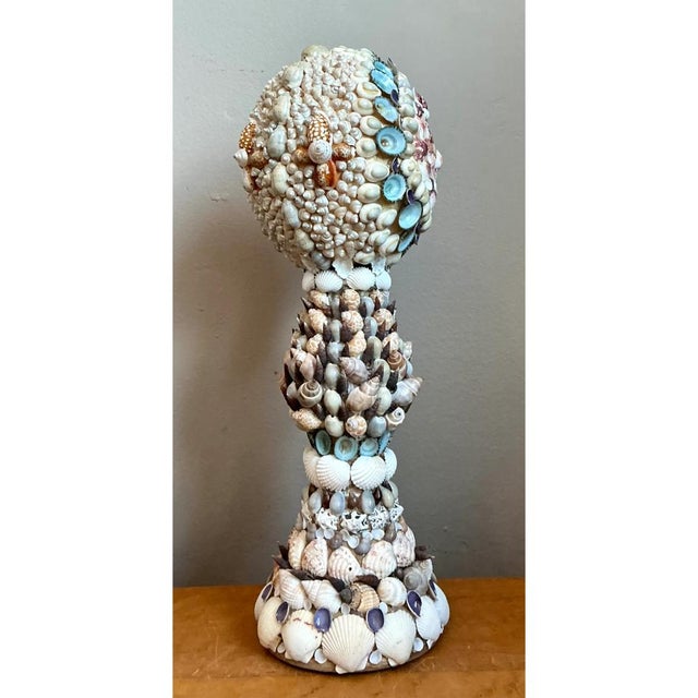 This vintage seashell encrusted sculpture is a mesmerizing example of intricate shellwork artistry, its striking mushroom-...