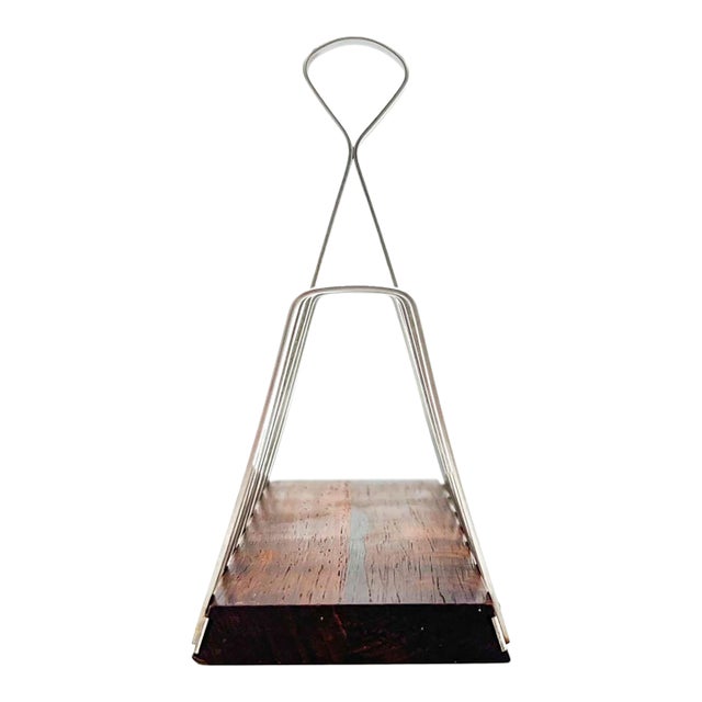 A 1960s Danish toast rack by Lundtofte, pairing a rich rosewood base with curved stainless steel dividers and a sculptural...