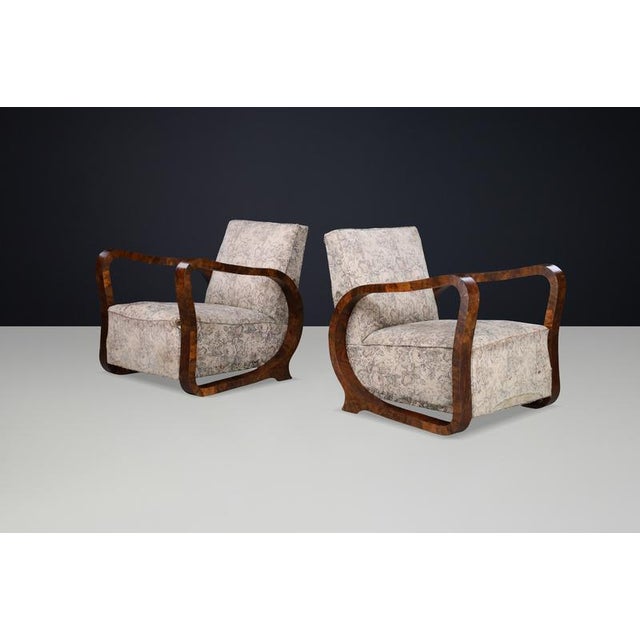 Sculptural Italian Art Deco club armchairs in richly figured burl wood, offered in original condition and ideal for...