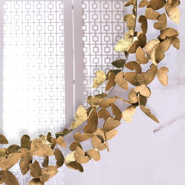 Hand-bent wings poise in a fluttery flight around the handcrafted mirror frame. Each mirror is one of a kind due to the...