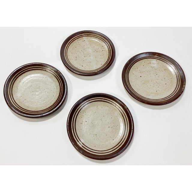 Unique set of four vintage studio pottery coasters with speckled gray and brown finish. Signed by maker. Natural age wear....