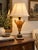Elegant vintage Neoclassical table lamp modeled after a classical two-handled urn, featuring a warm amber-brown marbleized...