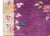 This exquisite 1930s Chinese Art Deco rug features a vibrant purple field adorned with an elegant natural design of...