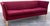 A Danish modern sofa upholstered in a classic deep red fabric. The sofa is a simply designed 3 seat flared back sofa with...
