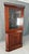 This c.1900 solid walnut corner cabinet features a tall, stately form with a glazed upper door, interior plate grooves,...