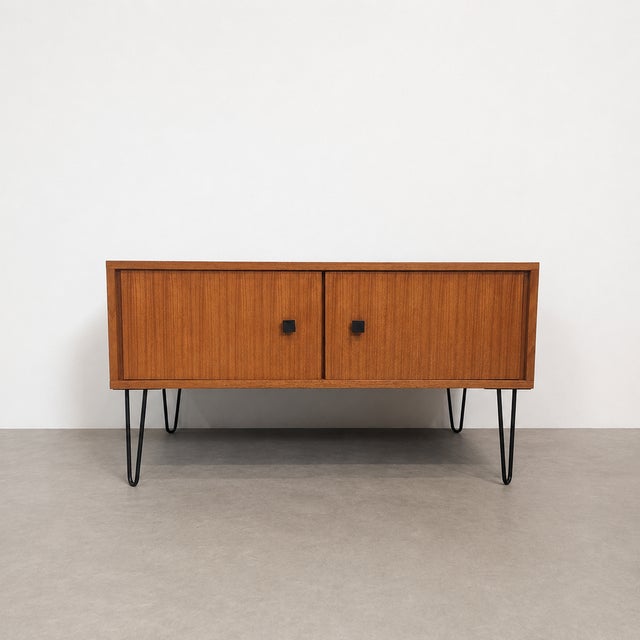 Belgian vintage lowboard by mdk, dating from the 1960s. the cabinet is crafted in teak and features two front doors with...