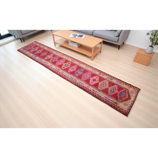 Handwoven in Anatolia during the 1980s, this striking Oushak runner blends timeless Turkish craftsmanship with versatile...