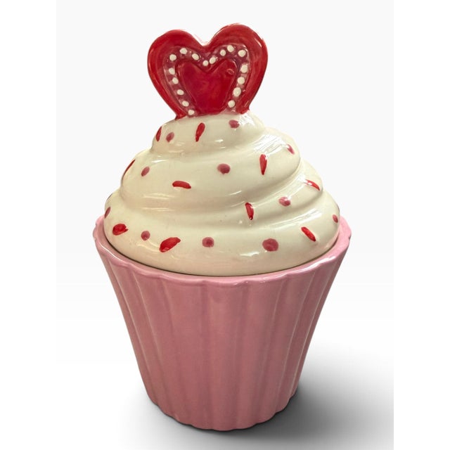 Whimsical vintage Nantucket Home ceramic cookie jar designed in the shape of a frosted cupcake. The piece features a soft...