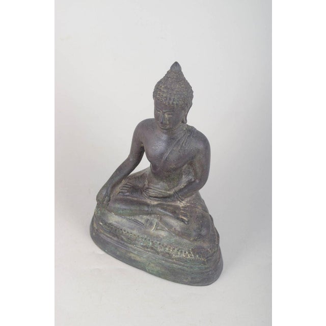 Bronze Buddha figure. Seated Buddha figure executed in patinated bronze with a classical meditative pose, stylised details...