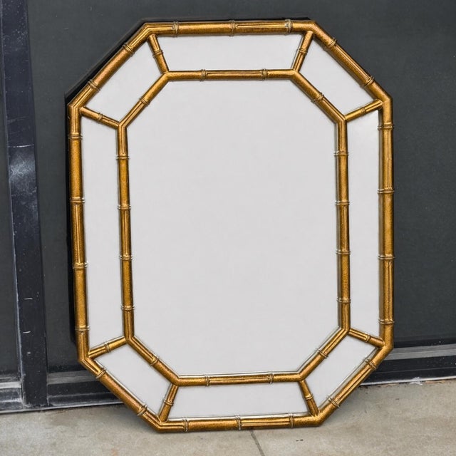 This is a pair of Hollywood Regency Era carved giltwood faux bamboo mirrors. They are Italian and unmarked. They have...