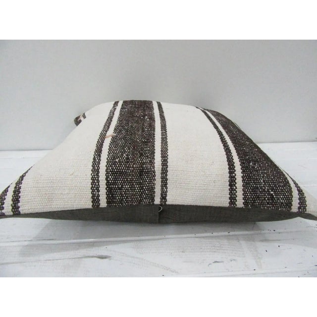 This is a pillow cover made from a vintage kilim rug. The piece was properly washed and ready to use. Pillow inserts not...