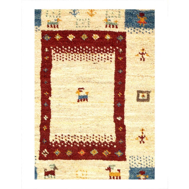 This Gabbeh Scatter Rug is made of high-quality old and rare Persian Gabbeh carpets. The piece was crafted with good...