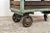 Tough cart from a textile factory. The cart has a metal frame and wooden slats and 3 wheels, one of which is a swivel...