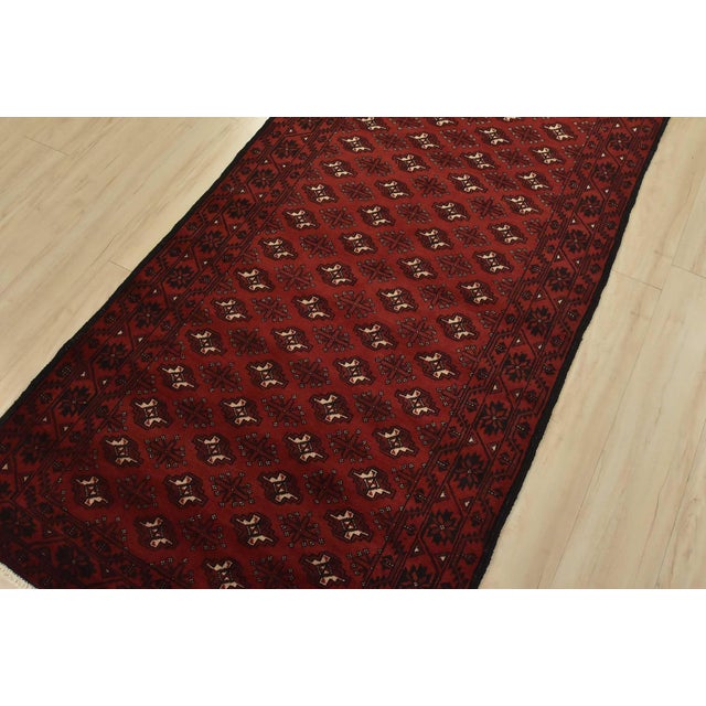 An authentic vintage tribal Baloch rug hand-knotted with fine wool and natural dyes. This nomadic oriental rug features...