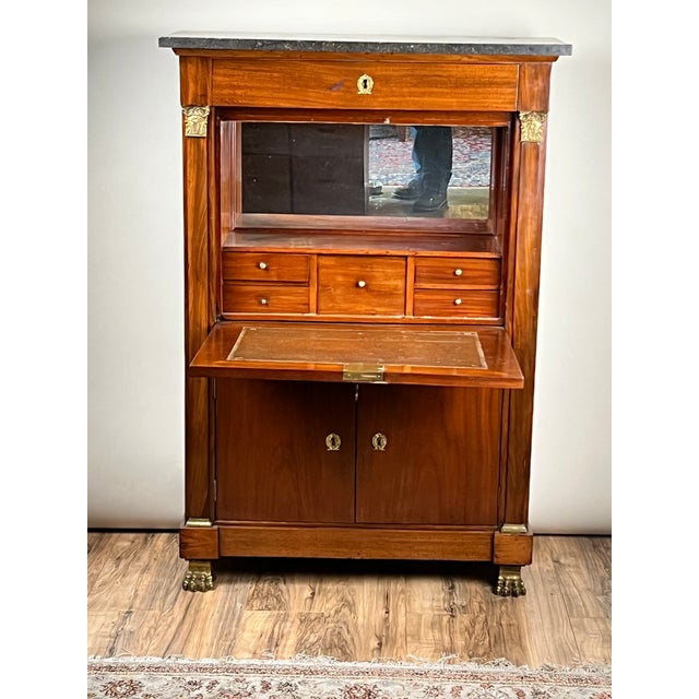 This elegant French Empire secrétaire abattant captures the refined architectural presence and restrained grandeur that...