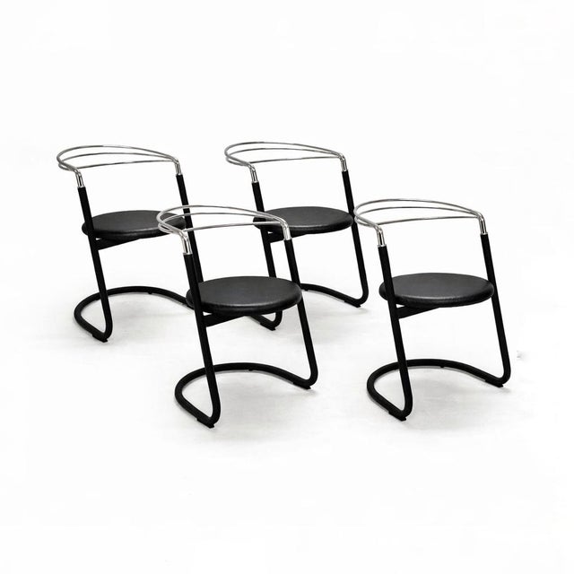 Set of four postmodern design chairs from the 1970s. Chrome-plated rod backrest, textured black lacquered metal cantilever...