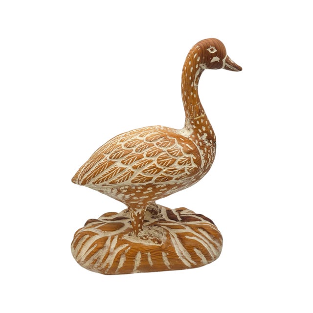 A goose, carved from solid wood, stands in quiet dignity upon its base. The artisan’s hand traced each feather, each dot,...