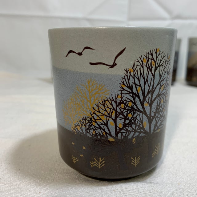 Offered here is a set of four vintage Japanese stoneware tea or sake cups featuring a hand-painted silhouette tree and...