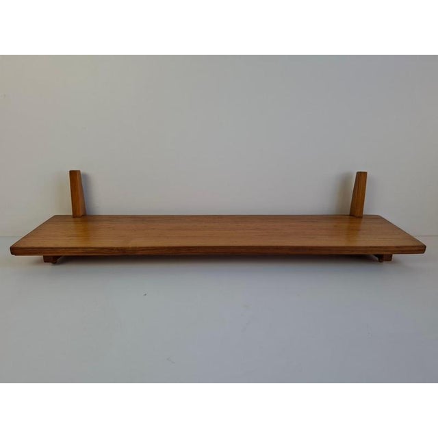 Elegant midcentury modern wall shelf designed and produced in Czechoslovakia during the 1960s. Made from solid wood, the...