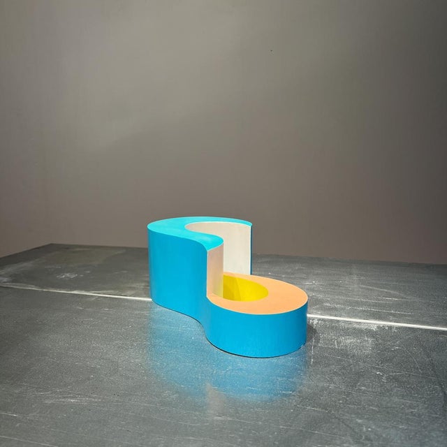 Govert Heikoop’s "Untitled" (1986) is a small, hand-signed sculpture crafted from painted plywood, measuring 9.0 x 25.0 x...