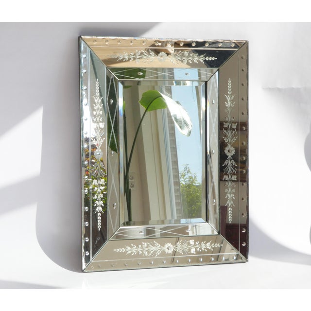 A large Venetian rectangular mirror with beveled glass. The mirror has a beautiful frame with engraved details .The main...