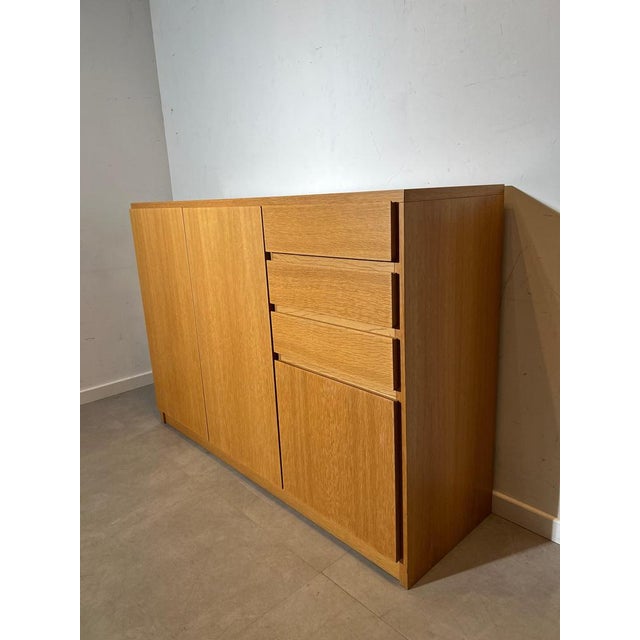 Timeless and minimalist solid oak sideboard by Vanda. This piece stands out through its clean architectural lines, warm...