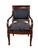 Commanding and deeply elegant, this antique Empire style armchair is a statement piece for the ages. The rich dark...