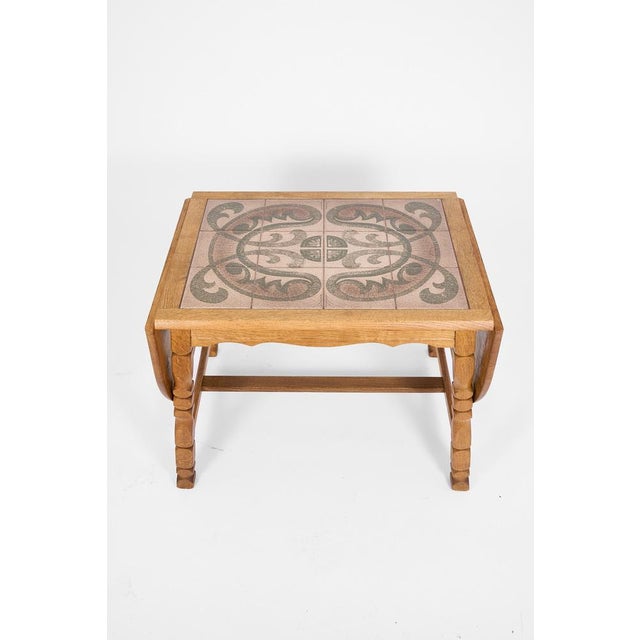 Decorative Scandinavian coffee table crafted in solid oak with an integrated ceramic tile top featuring an organic Art...