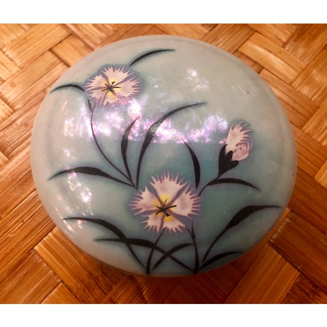 Lovely little round box! In the sweetest French blue hand-painted with floral motifs. Round in shape with 3 ball shaped...