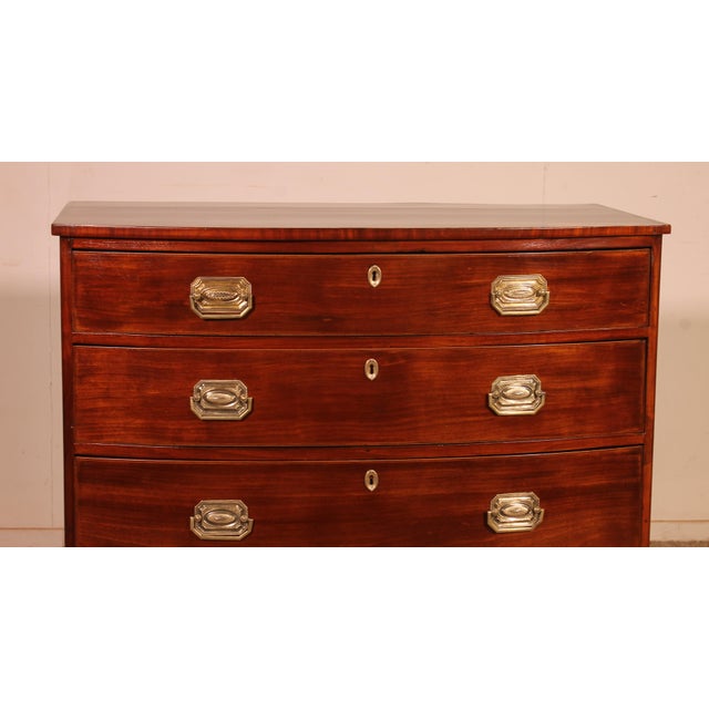 Exquisite bombé mahogany commode from the Regency period, circa 1800. This commode is of exceptional quality, featuring...