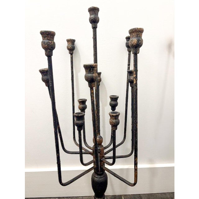A dramatic pair of candelabras from Vagabond Vintage, each boasting thirteen elegantly tiered arms that evoke the grandeur...