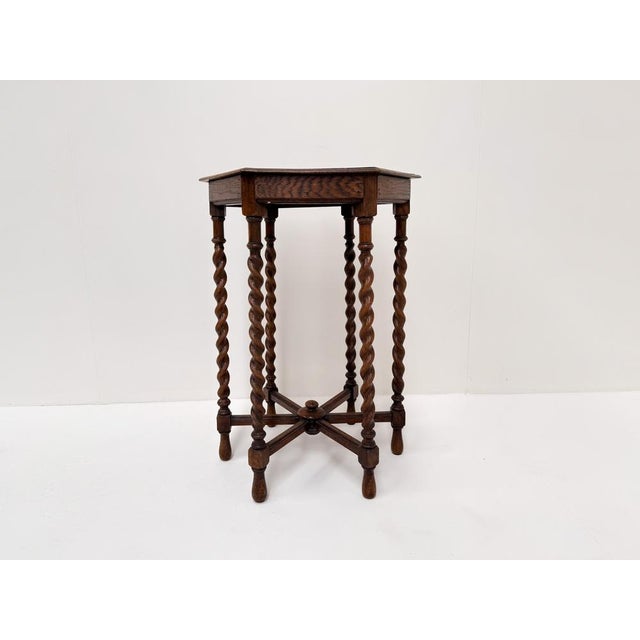 Charming antique hexagonal side table from the early 20th century, featuring a beautifully carved wooden top with...