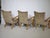 Three mid-century lounge chairs upholstered in velour from the 1960s. Curved wooden armrests and tapered wooden legs....